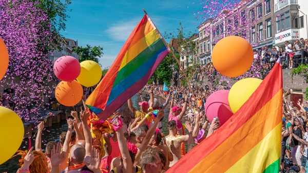 Foto genomen tijdens viering Utrecht Pride. Te zien zijn Pridevlaggen, confetti en ballonnen.